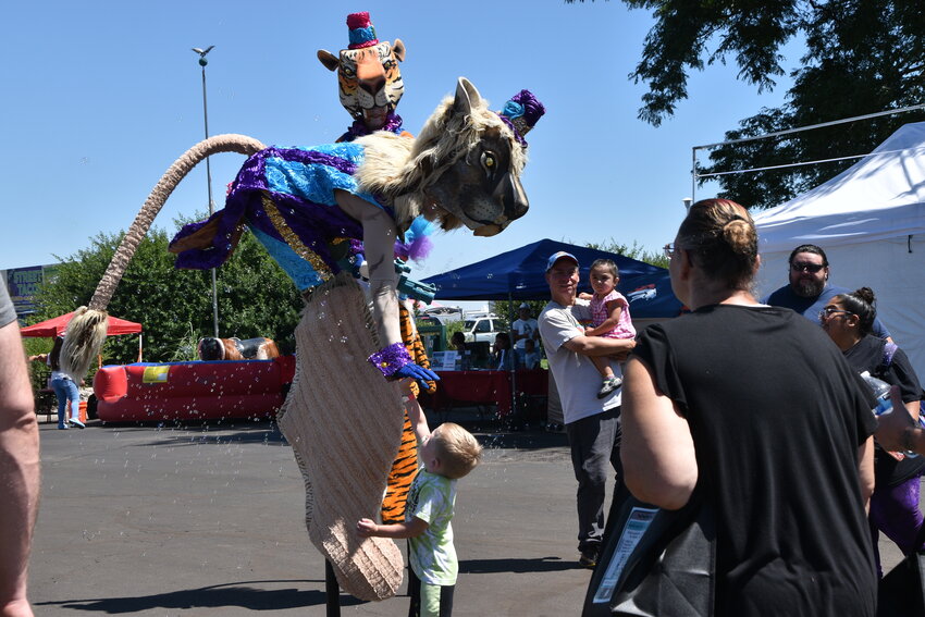 The giant puppet is giving high fives to everyone they meet and blowing bubbles on August 3.